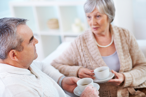 Portrait of mature man and his wife drinking tea and interacting